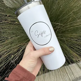 a hand holding a coffee cup