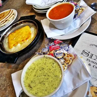 a table with soup, crackers, and crackers