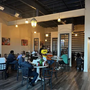 people sitting at tables in a restaurant