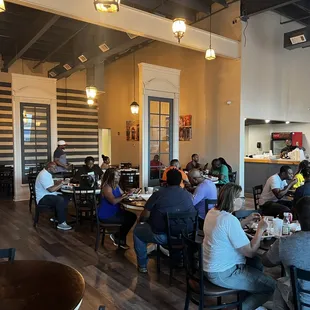people sitting at tables in a restaurant