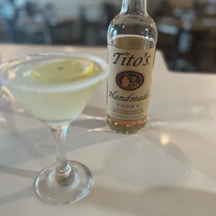 a martini and a bottle of tito&apos;s