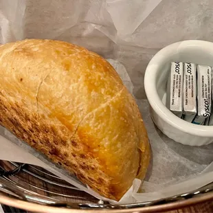 a basket of bread and a small bowl of toothpaste