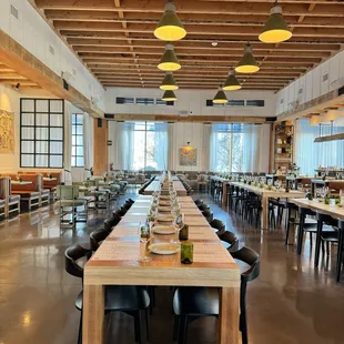 a long dining room with tables and chairs
