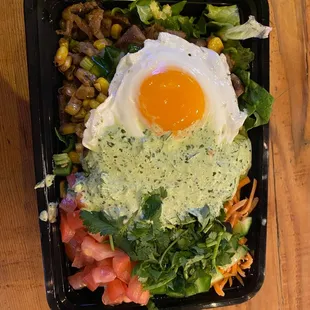 Pork salad bowl with egg on top