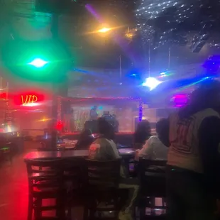 people sitting at tables in a restaurant