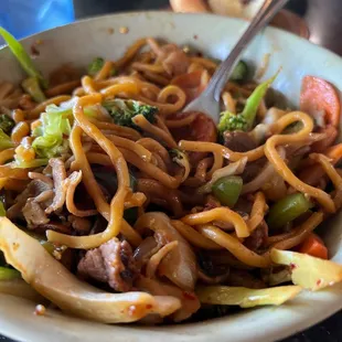 a bowl of stir fried noodles