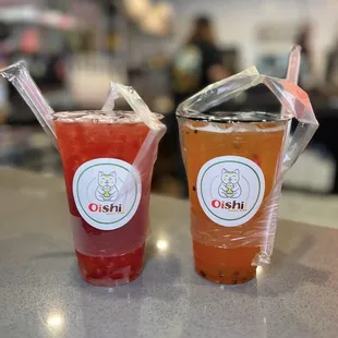 Mango Strawberry Iced Black Tea w/ Lychee Jelly and Cold Brew Passion Fruit Iced Green Tea w/ Strawberry Popping Boba