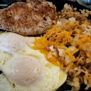 Sizzlin&apos; pork chop and eggs.