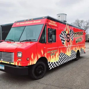 a red truck with flames on it