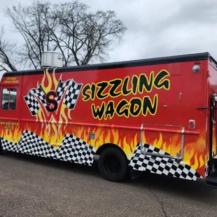 a red food truck with a checkered design