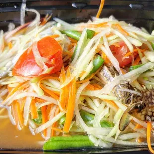 a close up of a salad in a plastic container