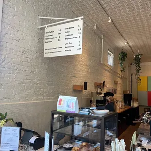 a coffee shop counter with pastries on it