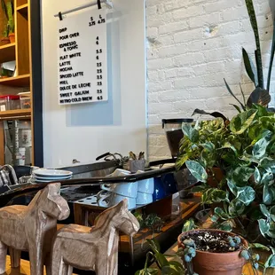 two wooden horses on a counter