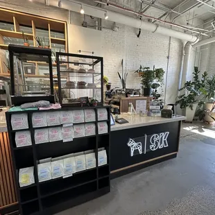 a coffee shop with a counter and shelves