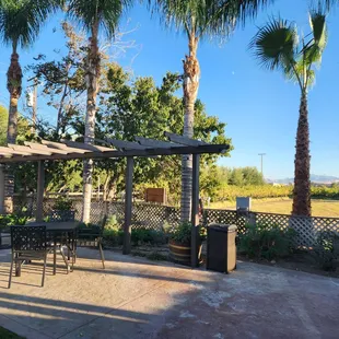 a patio with tables and chairs