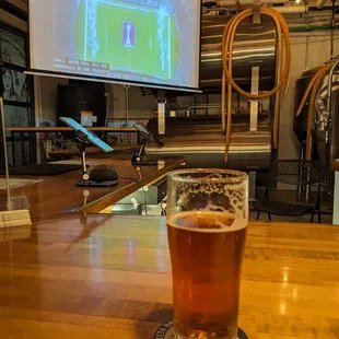a glass of beer on a bar