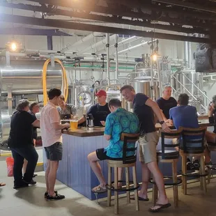 Indoor seating and bar area with brew tanks.