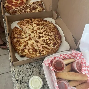 two pizzas in boxes