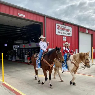 two children riding horses