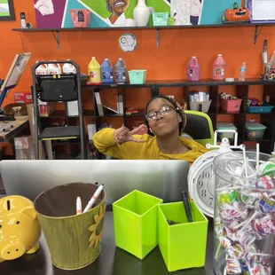 Our wonderful SketchNStudio staff member posing at her desk.