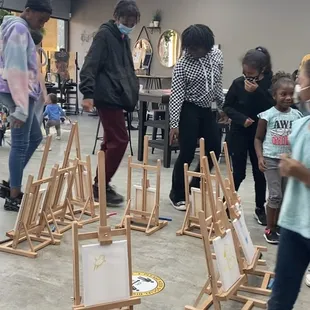 SketchNStudio supporters taking part in a game N-Studio known as &quot;Musical Easels&quot;