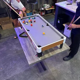 two people playing a game of pool