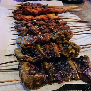 a variety of meats on skewers
