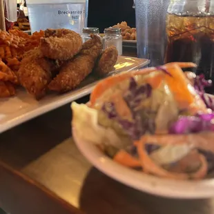 Cole slaw and chicken tenders and fries