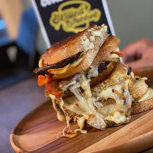 a stack of sandwiches on a wooden plate