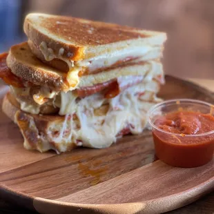 a stack of grilled cheese sandwiches with tomato sauce