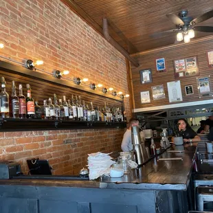 a bar with people sitting at the bar