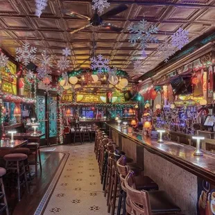 the interior of a bar decorated for christmas