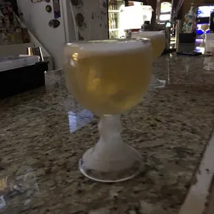 a glass of beer on a counter
