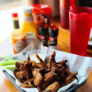 a plate of fried chicken wings and dipping sauce