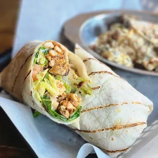 a burrito and a side dish