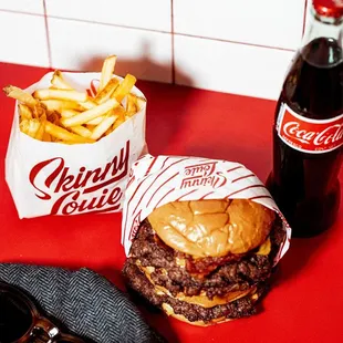 a hamburger and fries on a red counter