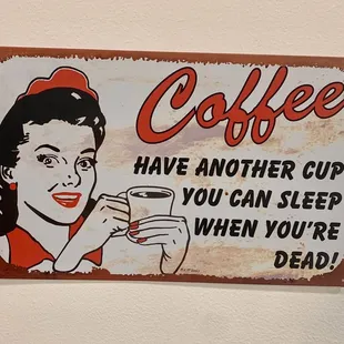 a woman holding a cup of coffee