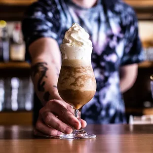a bartender holding a drink