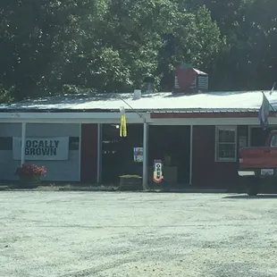 a red truck parked in front of the store
