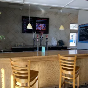 two wooden chairs at the counter