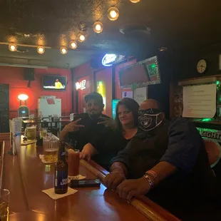 a group of people sitting at a bar