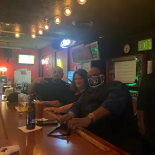 a group of people sitting at a bar