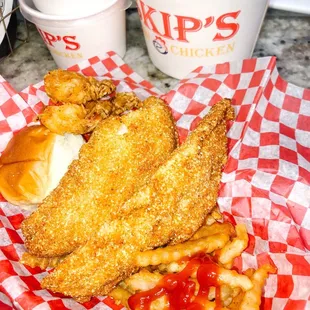 a basket of fried chicken and fries
