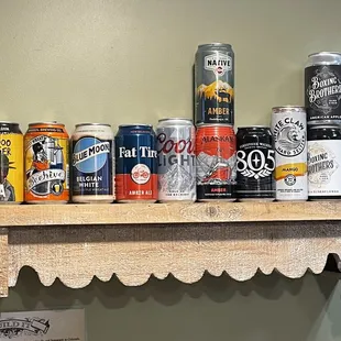 a variety of beer cans on a shelf