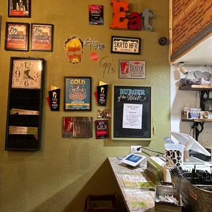 a kitchen counter with various items on the wall
