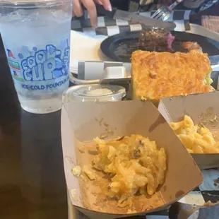 Steak and shrimp in the back Water cup in the front