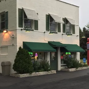 a white building with green awnings