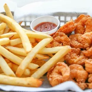a basket of fried shrimp and french fries
