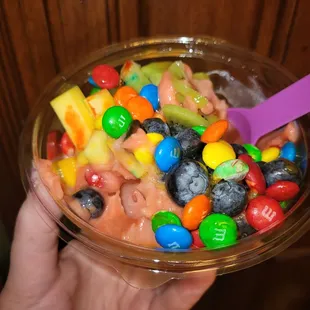 a bowl of fruit and candy