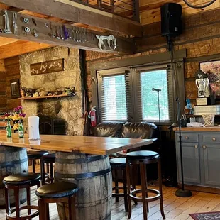 a bar with stools and a clock on the wall
